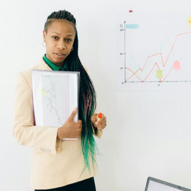 Woman in White Long Sleeve Shirt Holding White Paper